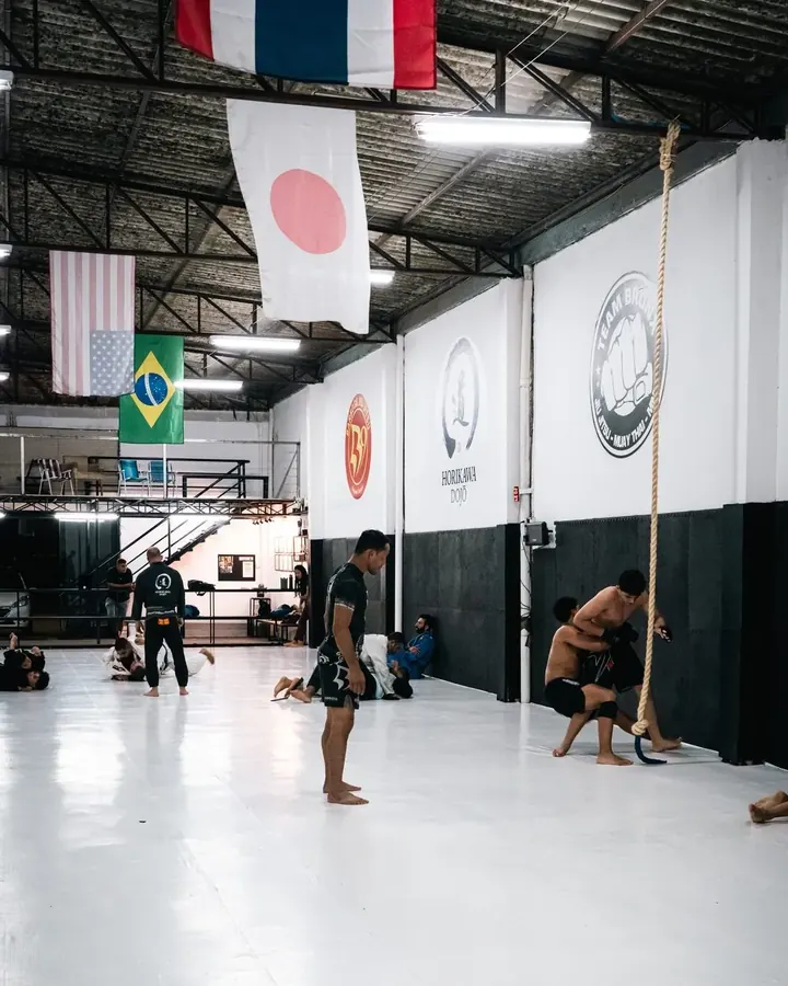 Tatame do Horikawa Dojo durante o treino, com as bandeiras penduradas no teto